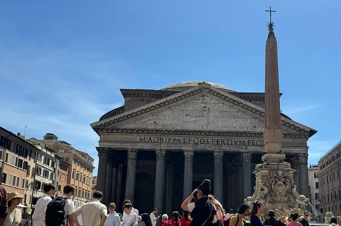 The Pantheon and the obelisk fountain on Piazza della Rotonda under a blue sky