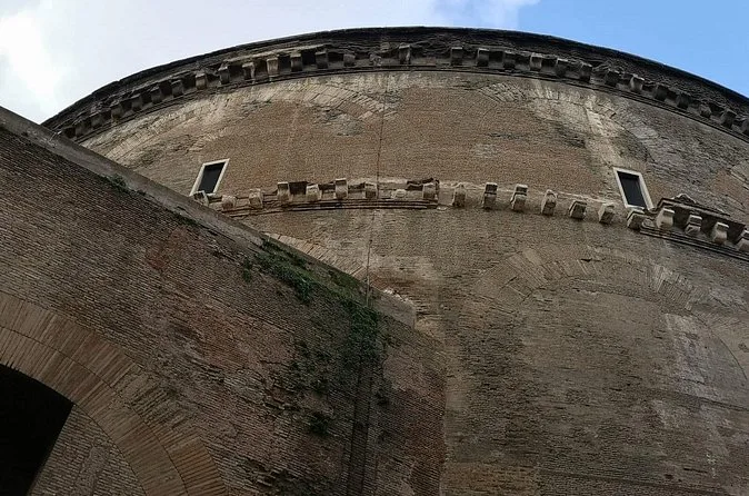 The curved brick drum of the Pantheon seen from the side street
